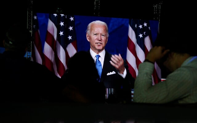 Supporters watch the program outside the venue where Democratic presidential candidate former vice president Joe Biden is speaking, during the final day of the Democratic National Convention, Thursday, Aug. 20, 2020, at the Chase Center in Wilmington, Del. (AP Photo/Carolyn Kaster)