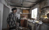 Homeowner Osnat Malka inspects damage from a rocket fired overnight from the Gaza Strip, in Sderot, Israel, Aug. 21, 2020 (AP Photo/Tsafrir Abayov)