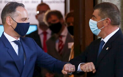 German Foreign Minister Heiko Maas, left, and his Israeli counterpart Gabi Ashkenazi bump elbows as they meet at the House of the Wannsee Conference in Berlin, August 27, 2020. (Michele Tantussi/Pool Photo via AP)