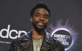 In this Nov. 24, 2019 file photo, Chadwick Boseman poses in the press room at the American Music Awards at the Microsoft Theater in Los Angeles (Photo by Jordan Strauss/Invision/AP, File)
