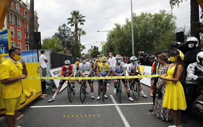 Riders wearing face masks as they wait for the start of the first stage of the Tour de France cycling race in Nice, southern France, August 29, 2020. (AP Photo/Christophe Ena)