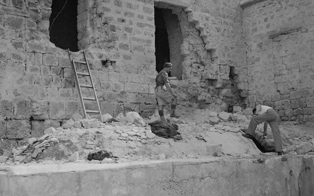 Two men look over debris beneath shattered windows of Acre Prison, north of Haifa, British-Mandate Palestine, May 6, 1947, which was blasted open two days earlier by members of an underground Jewish militia. (AP Photo) Two men look over debris beneath shattered windows of Acre Prison, north of Haifa, British-Mandate Palestine, May 6, 1947, which was blasted open two days earlier by members of an underground Jewish militia. (AP Photo)