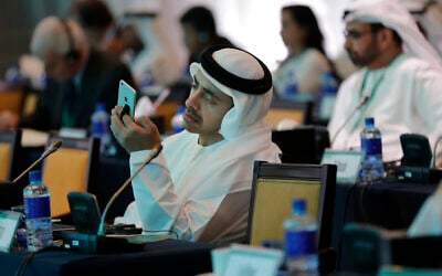United Arab Emirates Foreign Minister Sheik Abdullah bin Zayed Al Nahyan checks his phone during the 10th International Institute for the Strategic Studies in Manama, Bahrain,  December 6, 2014. (AP Photo/Hasan Jamali/File)