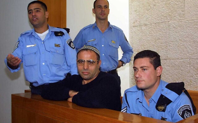 Yona Avrushmi, center, who killed protester Emil Grunzweig with a grenade thrown at a peace rally in 1983, on the day of his release from prison after serving a life sentence on January 26, 2011. (Flash90) Yona Avrushmi, center, who killed protester Emil Grunzweig with a grenade thrown at a peace rally in 1983, on the day of his release from prison after serving a life sentence on January 26, 2011. (Flash90)
