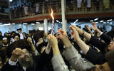 Illustrative: Ultra-Orthodox men light the Havdalah candle marking the end of the Jewish Shabbat, at a synagogue in the town of Uman, Ukraine, September 7, 2013. (Yaakov Naumi/Flash90)