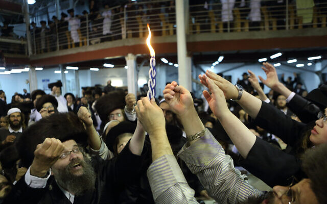Illustrative: Ultra-Orthodox men light the Havdalah candle marking the end of the Jewish Shabbat, at a synagogue in the town of Uman, Ukraine, September 7, 2013. (Yaakov Naumi/Flash90) Illustrative: Ultra-Orthodox men light the Havdalah candle marking the end of the Jewish Shabbat, at a synagogue in the town of Uman, Ukraine, September 7, 2013. (Yaakov Naumi/Flash90)
