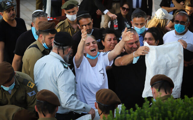 Nava Revivo, center, mother of late IDF soldier Amit Ben-Ygal, cries at his funeral at the cemetery in Be'er Ya'akov, May 12, 2020. (Yossi Aloni/Flash90) Nava Revivo, center, mother of late IDF soldier Amit Ben-Ygal, cries at his funeral at the cemetery in Be'er Ya'akov, May 12, 2020. (Yossi Aloni/Flash90)