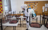 Workers disinfect a classroom at the Gymnasia Rehavia high school in Jerusalem on June 3, 2020. (Yonatan Sindel/Flash90)