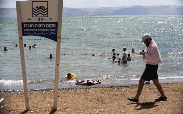 People enjoy the beaches of the Sea of Galilee in northern Israel, June 19, 2020. (David Cohen/Flash90) People enjoy the beaches of the Sea of Galilee in northern Israel, June 19, 2020. (David Cohen/Flash90)