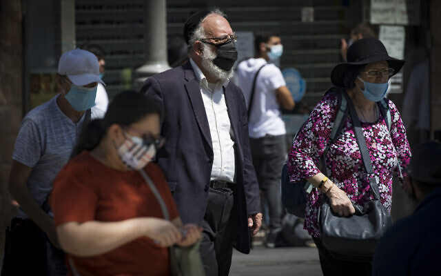 Jerusalemites wearing face masks for fear of coronavirus on Jaffa Road in the center of Jerusalem on August 2, 2020. (Olivier Fitoussi/Flash90) Jerusalemites wearing face masks for fear of coronavirus on Jaffa Road in the center of Jerusalem on August 2, 2020. (Olivier Fitoussi/Flash90)
