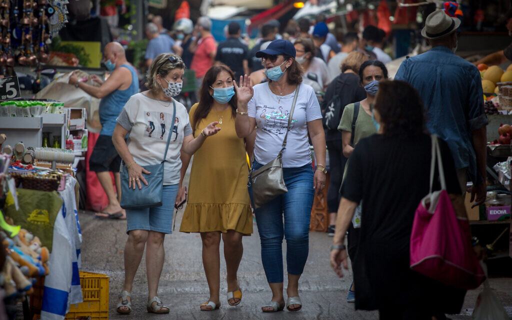 Israelis wear protective face masks as they shop for food at the Carmel market in Tel Aviv on August 5, 2020. (Miriam Alster/FLASh90) Israelis wear protective face masks as they shop for food at the Carmel market in Tel Aviv on August 5, 2020. (Miriam Alster/FLASh90)