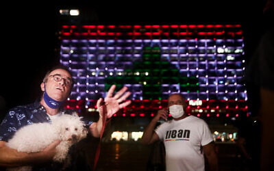 Tel Aviv city hall, on Rabin Square, is lit up with the Lebanese flag, in solidarity with the victims of the Beirut explosion, on August 5, 2020. (Miriam Alster/Flash90)