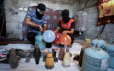 Palestinians in the southern Gaza city of Rafah prepare balloon-borne incendiary devices to be launched toward Israel on August 8, 2020. (Abed Rahim Khatib/Flash90)