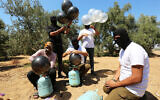 Palestinians prepare a flammable object to be flown toward Israel, near the Israel-Gaza border, in the eastern part of the Gaza Strip, August 10, 2020. (Abed Rahim Khatib/Flash90)