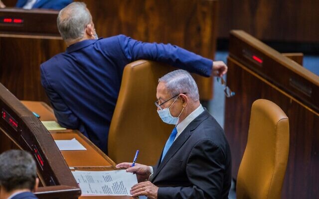 Alternate Prime Minister and Minister of Defense Benny Gantz (left) and Prime Minister Benjamin Netanyahu seen during a vote to stave off a budget deadline and thus avert elections, at the Knesset on August 24, 2020.(Oren Ben Hakoon/POOL) Alternate Prime Minister and Minister of Defense Benny Gantz (left) and Prime Minister Benjamin Netanyahu seen during a vote to stave off a budget deadline and thus avert elections, at the Knesset on August 24, 2020.(Oren Ben Hakoon/POOL)