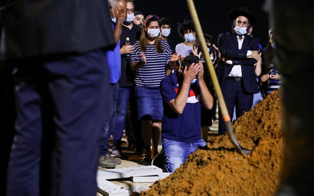 Family and friends attend the funeral of Rabbi Shai Ohayon, who was killed in a terror stabbing, at the Segula cemetery in Petah Tikva, August 27, 2020. (Noam Revkin Fenton/Flash90) Family and friends attend the funeral of Rabbi Shai Ohayon, who was killed in a terror stabbing, at the Segula cemetery in Petah Tikva, August 27, 2020. (Noam Revkin Fenton/Flash90)