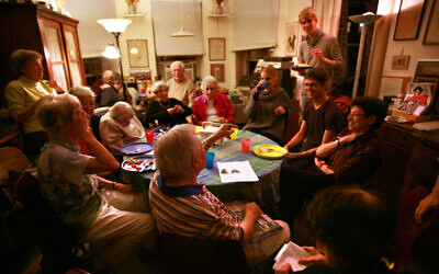 The weekly Stammtisch meetings, hosted in this photo by Gaby Glueckselig in 2015, draw young and old alike. (Courtesy Shani Bar On/ from 'Almost a Ritual' by Emil Rennert)