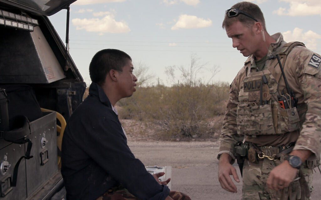 An officer from a CPB search and recovery unit in Arizona gives medical help to a Central American migrant who was abandoned by a border smuggler in the desert in Episode 6 of Netflix's 'Immigration Nation.' (Courtesy of NETFLIX © 2020)
