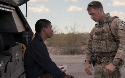 An officer from a CPB search and recovery unit in Arizona gives medical help to a Central American migrant who was abandoned by a border smuggler in the desert in Episode 6 of Netflix's 'Immigration Nation.' (Courtesy of NETFLIX © 2020)