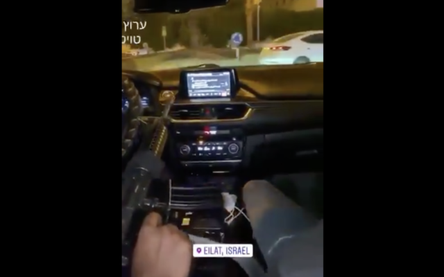 In a video circulated online, two unidentified men can be seen driving around Eilat with a loaded M-16 belonging to an IDF serviceman. (Screenshot) In a video circulated online, two unidentified men can be seen driving around Eilat with a loaded M-16 belonging to an IDF serviceman. (Screenshot)