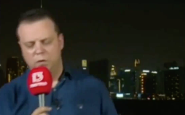 Channel 13's Doron Herman faints on air while reporting from Dubai on August 16, 2020. (Screen capture/ Twitter) Channel 13's Doron Herman faints on air while reporting from Dubai on August 16, 2020. (Screen capture/ Twitter)