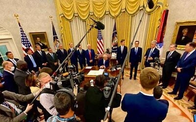 US President Donald Trump, with key administration officials around him in the Oval Office, announces that the United Arab Emirates and Israel have agreed to establish full diplomatic ties, August 13, 2020. (White House via Twitter)
