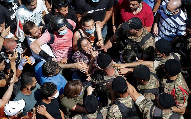 A woman yells at Lebanese soldiers during scuffles with soldiers as French President Emmanuel Macron a damaged area in Beirut, Lebanon, August 6, 2020. (AP Photo/Hassan Ammar) A woman yells at Lebanese soldiers during scuffles with soldiers as French President Emmanuel Macron a damaged area in Beirut, Lebanon, August 6, 2020. (AP Photo/Hassan Ammar)