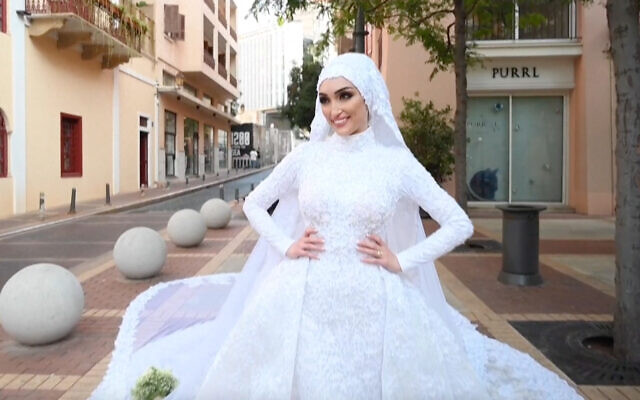 Dr. Israa Seblani during her wedding photo shoot moments before the Beirut blast tore through the city. (Screenshot/Mahmoud Nakib via AFP) Dr. Israa Seblani during her wedding photo shoot moments before the Beirut blast tore through the city. (Screenshot/Mahmoud Nakib via AFP)