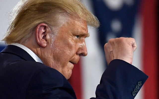 US President Donald Trump pumps his fist as he finishes speaking during an event at the Whirlpool Corporation facility in Clyde, Ohio, August 6, 2020. (AP Photo/Susan Walsh) US President Donald Trump pumps his fist as he finishes speaking during an event at the Whirlpool Corporation facility in Clyde, Ohio, August 6, 2020. (AP Photo/Susan Walsh)