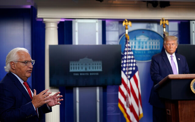 US President Donald Trump listens as US Ambassador to Israel David Friedman speaks at a news conference at the White House in Washington, August 13, 2020, after the announcement of fully normalized ties between Israel and the UAE. (AP Photo/Andrew Harnik)
