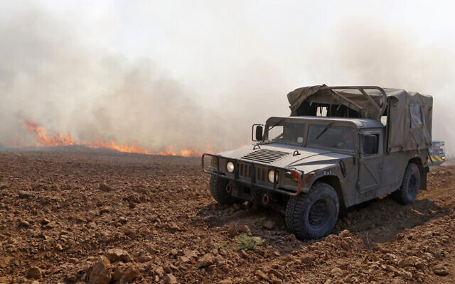 An IDF vehicle at the scene of a fire sparked by an incendiary balloon launched from the Gaza Strip, near Be'eri Kibbutz in southern Israel, on August 13, 2020. (Jack Guez/AFP) An IDF vehicle at the scene of a fire sparked by an incendiary balloon launched from the Gaza Strip, near Be'eri Kibbutz in southern Israel, on August 13, 2020. (Jack Guez/AFP)