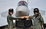 A pilot from Israel, left, and a pilot from Germany, right, pose in front of a Eurofighter at an airbase in Noervenich, Germany, August 20, 2020. (AP Photo/Martin Meissner)