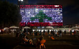 Tel Aviv municipality in Rabin square is lit up with the Lebanese flag in solidarity with the victims of the the Beirut port explosion, August 5, 2020. (Miriam Alster/Flash90)