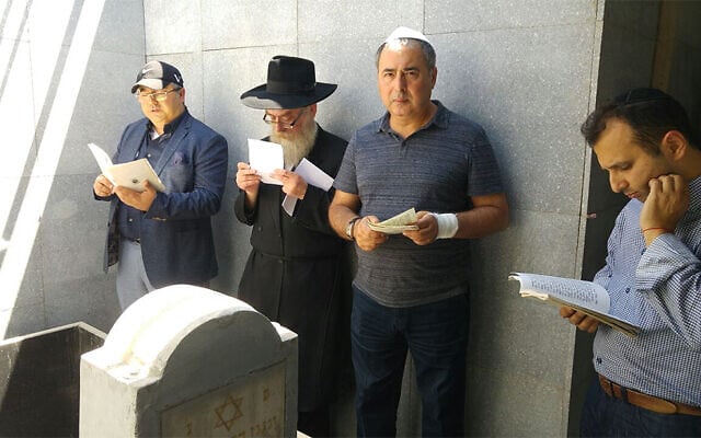 Men pray around the grave site of Levi Yitzchak Schneerson in Almaty, Kazakhstan in 2016. (Courtesy of Chabad Kazakhstan via JTA) Men pray around the grave site of Levi Yitzchak Schneerson in Almaty, Kazakhstan in 2016. (Courtesy of Chabad Kazakhstan via JTA)