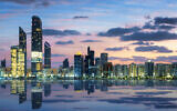 View of Abu Dhabi Skyline at sunset, United Arab Emirates (vwalakte; iStock by Getty Images)