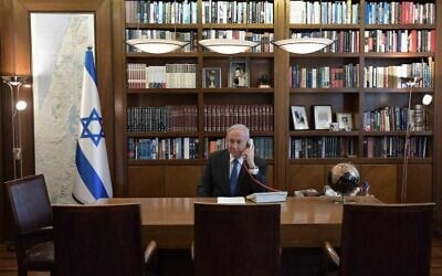 Prime Minister Benjamin Netanyahu at his office in Jerusalem on a phone call with UAE leader Mohammed Bin Zayed on August 13, 2020. (Kobi Gideon/PMO)