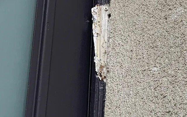 A piece of a broken mezuzah hangs on the doorframe of the Yismah Moché Synagogue in Paris, August, 14, 2020. (BNVCA via JTA) A piece of a broken mezuzah hangs on the doorframe of the Yismah Moché Synagogue in Paris, August, 14, 2020. (BNVCA via JTA)