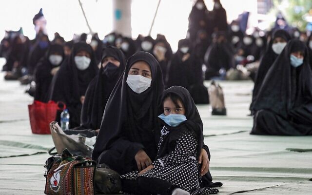 Shiite Muslim worshipers, mask-clad due to the COVID-19 coronavirus pandemic, attend the "Tasua" (ninth day) mourning ritual to commemorate the martyrdom of Prophet Mohammad's grandson Imam Hussein during the Islamic month of Muharram ahead of Ashura, at the Tehran University campus in Iran's capital on August 29, 2020. (AFP) Shiite Muslim worshipers, mask-clad due to the COVID-19 coronavirus pandemic, attend the "Tasua" (ninth day) mourning ritual to commemorate the martyrdom of Prophet Mohammad's grandson Imam Hussein during the Islamic month of Muharram ahead of Ashura, at the Tehran University campus in Iran's capital on August 29, 2020. (AFP)