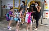 Schoolteachers speak with students on the first day of school, during the coronavirus pandemic, in Tel Aviv on September 1, 2020. (JACK GUEZ / AFP)