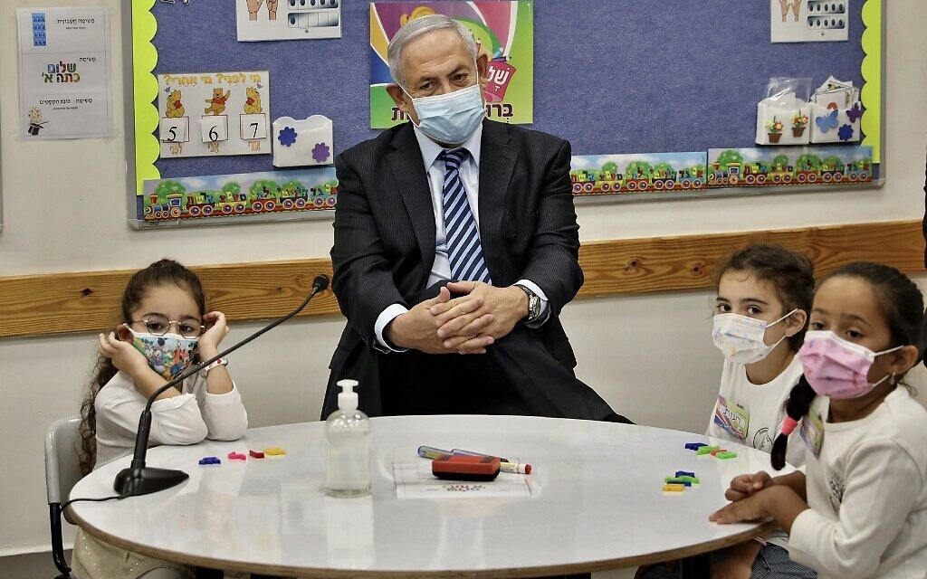 Prime Minister Benjamin Netanyahu meets schoolchildren as he attends a ceremony to mark the start of the school year in Mevo Horon on September 1, 2020. (Marc Israel Sellem/Pool/AFP) Prime Minister Benjamin Netanyahu meets schoolchildren as he attends a ceremony to mark the start of the school year in Mevo Horon on September 1, 2020. (Marc Israel Sellem/Pool/AFP)