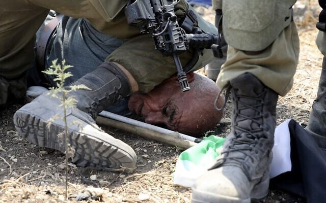 Israeli soldiers detain a Palestinian protester during a demonstration against Israeli settlement expansion in the village of Shufah, southeast of Tulkarm in the West Bank, on September 1, 2020. (Photo by JAAFAR ASHTIYEH / AFP) Israeli soldiers detain a Palestinian protester during a demonstration against Israeli settlement expansion in the village of Shufah, southeast of Tulkarm in the West Bank, on September 1, 2020. (Photo by JAAFAR ASHTIYEH / AFP)