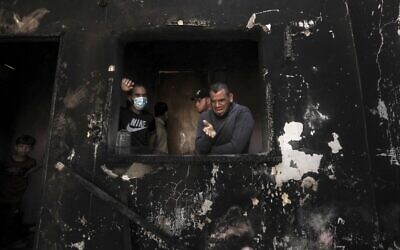Palestinian man Omar al-Hazeen (R) reacts at his torched house where his three children were killed in a fire ignited by a candle used to light up their room during a power cut in al-Nusirat refugee camp in the central Gaza Strip on September 2, 2020. In response to the persistent arson balloon launches from the Gaza Strip, Israel has banned fishing off Gaza's coast and closed the Kerem Shalom goods crossing, cutting off deliveries of fuel to the territory's sole power plant. Power had been in short supply even before the shutdown, with consumers having access to mains electricity for only around eight hours a day. (MAHMUD HAMS / AFP)
