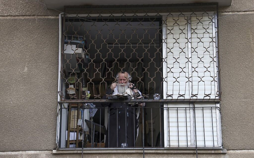 A man prays in his home in the ultra-Orthodox city of Bnei Brak, September 6, 2020. (MENAHEM KAHANA/AFP) A man prays in his home in the ultra-Orthodox city of Bnei Brak, September 6, 2020. (MENAHEM KAHANA/AFP)