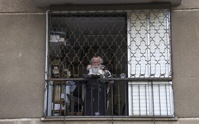 A man prays in his home in the ultra-Orthodox city of Bnei Brak, September 6, 2020. (MENAHEM KAHANA/AFP)