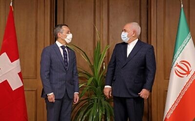 Iran's Foreign Minister Mohammad Javad Zarif, right, welcomes his Swiss counterpart Ignazio Cassis in the Iranian capital Tehran on September 7, 2020. (Photo by ATTA KENARE / AFP)