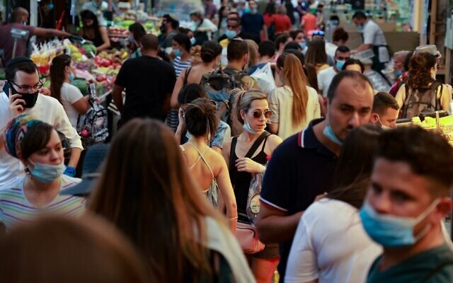 Shoppers, some wearing face masks against the coronavirus, crowd Jerusalem's Mahane Yehuda market on September 11, 2020. (Emmanuel Dunand/AFP) Shoppers, some wearing face masks against the coronavirus, crowd Jerusalem's Mahane Yehuda market on September 11, 2020. (Emmanuel Dunand/AFP)
