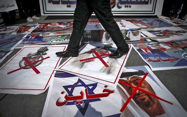 A demonstrator walks on pictures laid out on the ground depicting X-marks over the faces of Bahrain's King Hamad bin Isa al-Khalifa and Abu Dhabi Crown Prince Sheikh Mohammed bin Zayed al-Nahyan, during a protest against the United Arab Emirates' and Bahrain's decisions to normalize relations with Israel, in Gaza City on September 15, 2020. (Mohammed ABED / AFP) A demonstrator walks on pictures laid out on the ground depicting X-marks over the faces of Bahrain's King Hamad bin Isa al-Khalifa and Abu Dhabi Crown Prince Sheikh Mohammed bin Zayed al-Nahyan, during a protest against the United Arab Emirates' and Bahrain's decisions to normalize relations with Israel, in Gaza City on September 15, 2020. (Mohammed ABED / AFP)