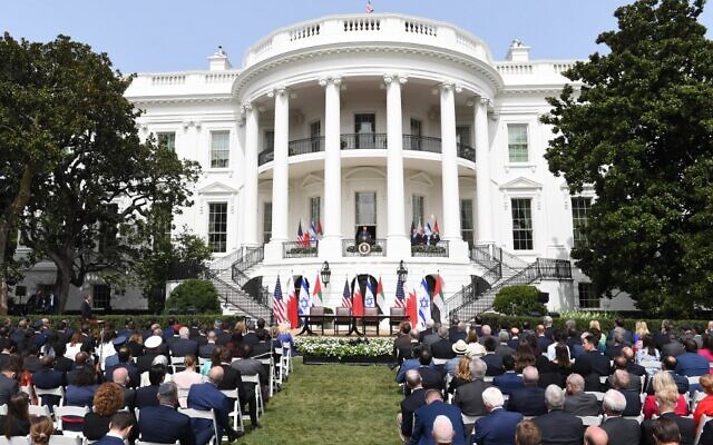 An audience watches as US President Donald Trump speaks from the Truman Balcony at the White House during the signing ceremony of the Abraham Accords where the countries of Bahrain and the United Arab Emirates normalize ties with Israel, on the South Lawn of the White House in Washington, DC, September 15, 2020 (SAUL LOEB / AFP) An audience watches as US President Donald Trump speaks from the Truman Balcony at the White House during the signing ceremony of the Abraham Accords where the countries of Bahrain and the United Arab Emirates normalize ties with Israel, on the South Lawn of the White House in Washington, DC, September 15, 2020 (SAUL LOEB / AFP)