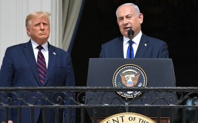 US President Donald Trump watches as Israeli Prime Minister Benjamin Netanyahu (R) speaks from the Truman Balcony at the White House during the signing ceremony of the Abraham Accords where the countries of Bahrain and the United Arab Emirates recognize Israel, on the South Lawn of the White House in Washington, DC, September 15, 2020. (Photo by SAUL LOEB / AFP)
