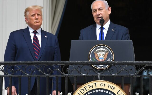 US President Donald Trump watches as Israeli Prime Minister Benjamin Netanyahu (R) speaks from the Truman Balcony at the White House during the signing ceremony of the Abraham Accords where the countries of Bahrain and the United Arab Emirates recognize Israel, on the South Lawn of the White House in Washington, DC, September 15, 2020 (SAUL LOEB / AFP)